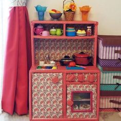 a doll house with lots of toys on top of it's shelves and drawers