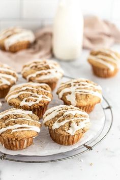 muffins with white frosting on a glass plate