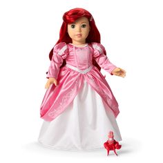 the doll is wearing a pink and white dress with red trims on it's head