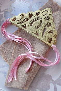 two napkins with pink and gold ribbons on them