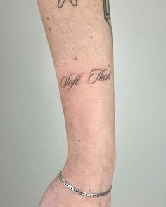 a person with a tattoo on their arm that says, off the heart and an arrow