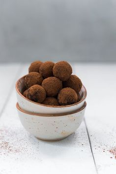 a bowl filled with chocolate truffles on top of a white counter