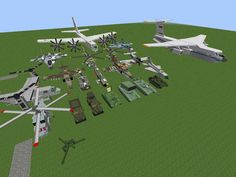 a bunch of different types of airplanes and tanks in a field with grass on the ground