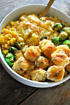 a white bowl filled with food on top of a wooden table