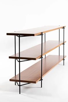 three wooden shelves with black metal legs against a white background, one is empty and the other has two open shelvings