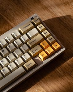 a computer keyboard sitting on top of a wooden table