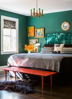 a bedroom with green walls and wooden floors