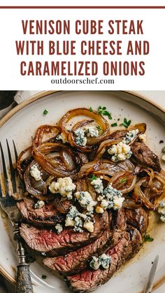 steak with blue cheese and caramelized onions served on a white plate next to a fork