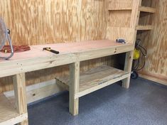 the workbench is made from wood and has tools on it