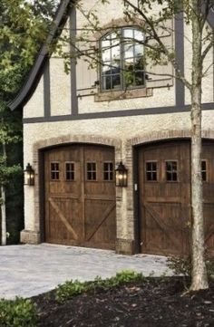 two brown garage doors in front of a house