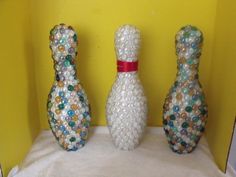 three decorative bowling pins sitting next to each other