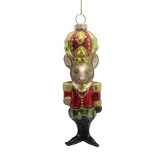 a glass ornament in the shape of a nutcracker wearing a red and gold outfit