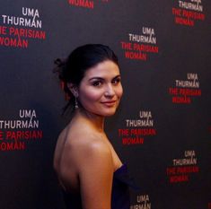 a woman standing in front of a red carpet with the words uma thurman the persian woman on it