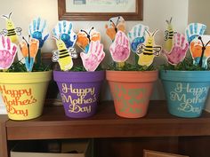 three flower pots with handprints on them and the words happy mother's day