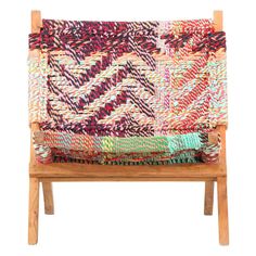 a wooden chair with multicolored fabric on it