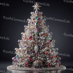 a silver christmas tree with lots of colorful jewels