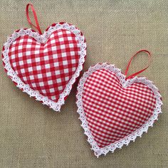 two red and white hearts with lace on them