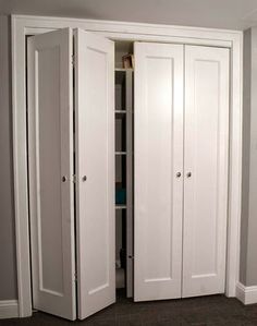 an empty room with two white closets in it