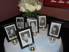 a table with pictures and candles on it