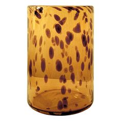 a glass vase with brown spots on it