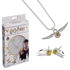 two harry potter necklaces are in front of a box with an image of the clock