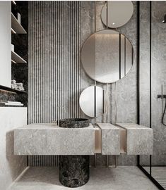 a bathroom with marble counter tops and round mirrors