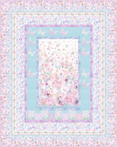 a blue and white quilt with pink flowers on the front, butterflies in the background