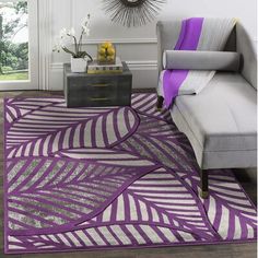 a living room filled with furniture and a purple rug