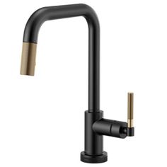 a black faucet with gold handles and two brass spoutes on the side