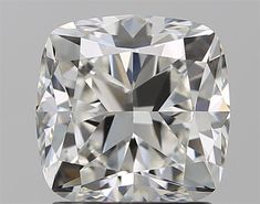 a cushion cut diamond on a gray background with the center stone in the shape of a square