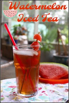 watermelon iced tea in a tall glass on a table next to a slice of watermelon