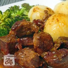 some meat and potatoes on a plate with broccoli