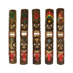 four tiki masks are lined up against a white background