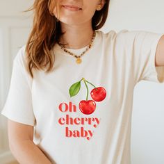 Cherry t shirt | summer t shirt | fruity t shirt | graphic tee FEATURES  -Premium Unisex T-Shirt -Fabric 100% cotton -Machine wash: warm (max 40C or 105F); Non-chlorine: bleach as needed; Tumble dry: medium; Do not iron; Do not dryclean. Please see the product images for help with sizing/our size guide. ABOUT CATTYWAMPUS SHOP Cattywampus is an old word, meaning fierce, and slightly awkward. A bit like us.  We are nothing to do with cats, but we do love them. We make bold, original and quirky gra Trendy Crew Neck T-shirt With Cherry Print, Retro Summer T-shirt With Front Print, White Print Text T-shirt For Summer, Red Graphic Print T-shirt For Summer, Fun Summer T-shirt With Front Print, Cute Cherry Print T-shirt For Summer, Retro Text Print T-shirt For Summer, Cotton T-shirt With Cherry Print And Crew Neck, Relaxed Fit T-shirt With Fruit Print For Spring