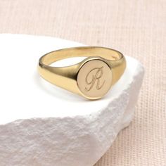 PRODUCT DESCRIPTION * Our Ladies 9ct Yellow Gold Personalised Round Signet Ring can be personalised with an initial to create a bespoke gift that can be worn every day. * Crafted from solid 9ct gold, its classic round design makes it suitable for ladies and women of all ages. *This engraveable signet ring becomes a unique and cherished keepsake, making it an ideal personalised gift. Treat yourself to a touch of luxury or surprise a loved one with this solid gold symbol of sentiment. Discover the Classic Personalized Initial Ring With Round Band, Rose Gold Signet Ring With Initials For Gift, Classic Rose Gold Signet Ring Gift, Yellow Gold Initial Ring With Monogram, Personalized Initials 14k Gold Rings, Personalized 14k Gold Rings With Initials, Classic Personalized Engraved Ring With Round Band, Classic Round Jewelry For Personalized Gift, Classic Personalized Engraved Round Band Ring