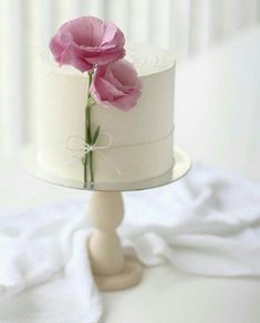 a white cake with pink flowers on top