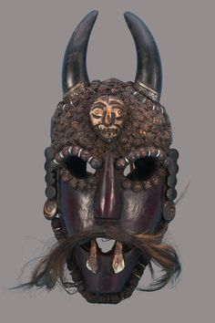 an elaborate mask with horns and long hair