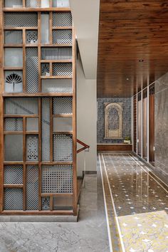 a large wooden book case sitting in the middle of a room next to a tiled floor