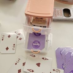 playing cards and dice on a table with other items in the backgroup