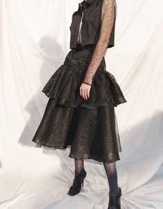 A high-waisted skirt that drapes just below the knee is layered with sheer tulle. A shimmer of tiers is styled with 2 adjustable straps. Multiple voluminous layers are hand ruched and secured on the edge of the hip strap.Highlights:- Tiered skirt - Full circle voluminous skirt - Tulle overlay - Woven strap - Metal buckle back closure- Adjustable strap- Metallic appearance- Calf length Fabrication: 20% nylon / 33% polyester / 47% lurex / 100%nylon Model Height: 5'9''Product size on model: SGarmen Cropped Button Down, Cropped Shirt, Tiered Skirt, Crop Shirt, Shirt Sale, Lace Sleeves, Skirts For Sale, Sheer Lace, Long Sleeve Lace