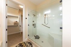 a walk in shower sitting inside of a bathroom