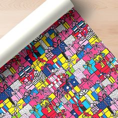 a colorful wrapping paper on top of a wooden table