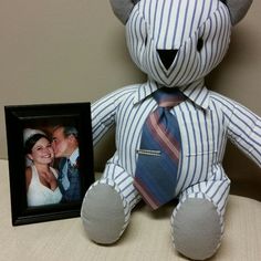 a teddy bear with a tie and photo frame