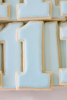 the number one cookies are decorated in blue icing