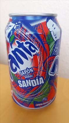 a can of soda sitting on top of a wooden table