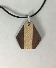 I make these unique pendants from a combination of walnut (dark) and maple (light). The finish is oil based polyurethane. Included is a soft nylon cord with all necessary hardware. comes ready to wear. Brown Necklace With Natural Variations For Gifts, Brown Wooden Pendant Jewelry, Natural Wood Jewelry With Natural Variations As Gift, Brown Wooden Necklace Gift, Natural Wood Jewelry With Variations As A Gift, Natural Wood Jewelry With Variations For Gifts, Natural Wood Jewelry With Variations For Gift, Brown Wooden Necklace For Gifts, Brown Wood Necklace As Gift