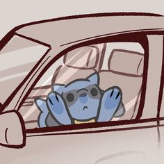 a blue monkey sitting in the passenger seat of a car