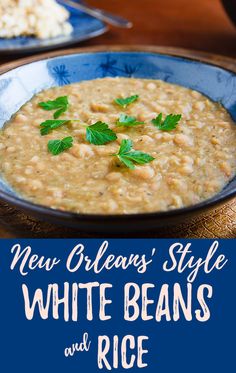 white beans and rice in a blue bowl with parsley garnish on top