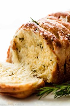 sliced loaf of bread with herbs on top