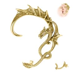 a gold brooch with a dragon on it's back and an earring in the middle